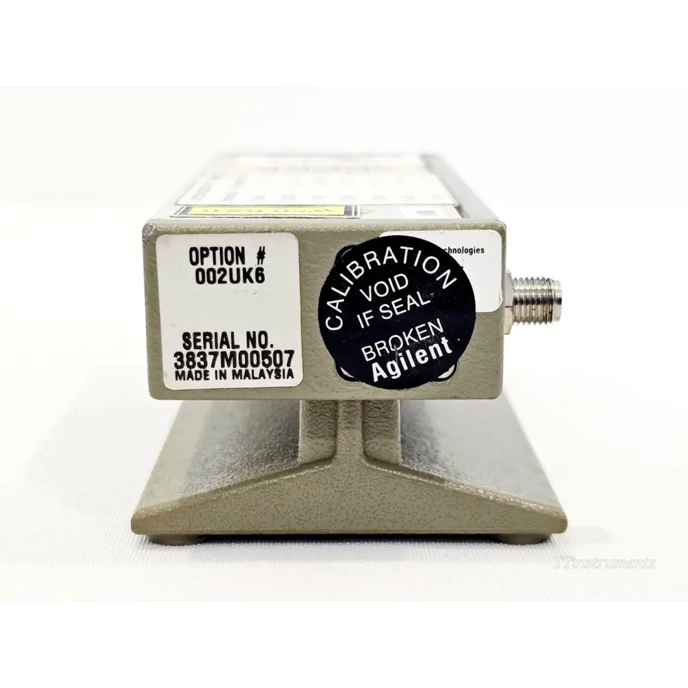 Agilent 8495H attenuator opposite end showing Option 002UK6 label, serial number 3837M00507, and Agilent calibration void seal