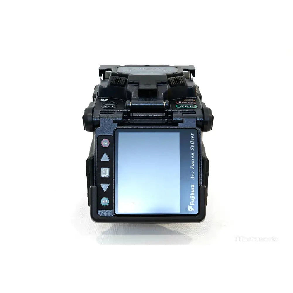 Fujikura FSM-18R fusion splicer top-down view with wind cover open revealing V-groove fibre holder and electrode assembly