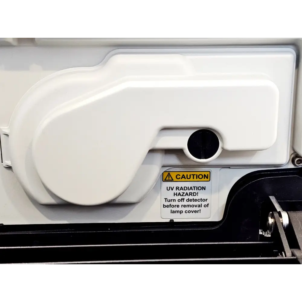 Dionex VWD-3400RS UV lamp housing with UV radiation hazard caution label visible inside detector compartment