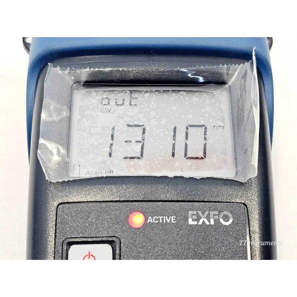 EXFO FLS-600 LCD close-up displaying active 1310 nm CW output with ACTIVE LED illuminated red