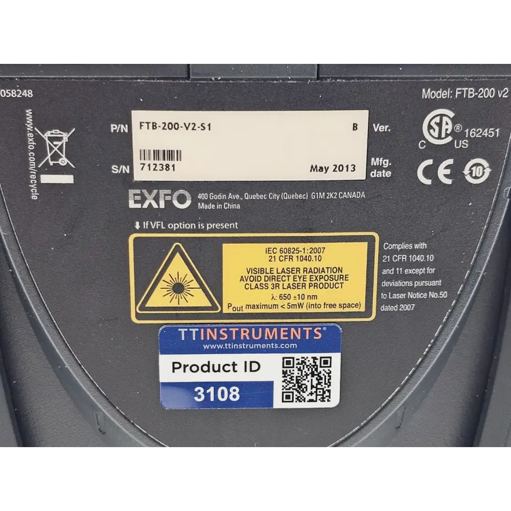 EXFO FTB-200 V2 product label close-up: model FTB-200 v2, P/N FTB-200-V2-S1, S/N 712381, May 2013 with laser safety warning