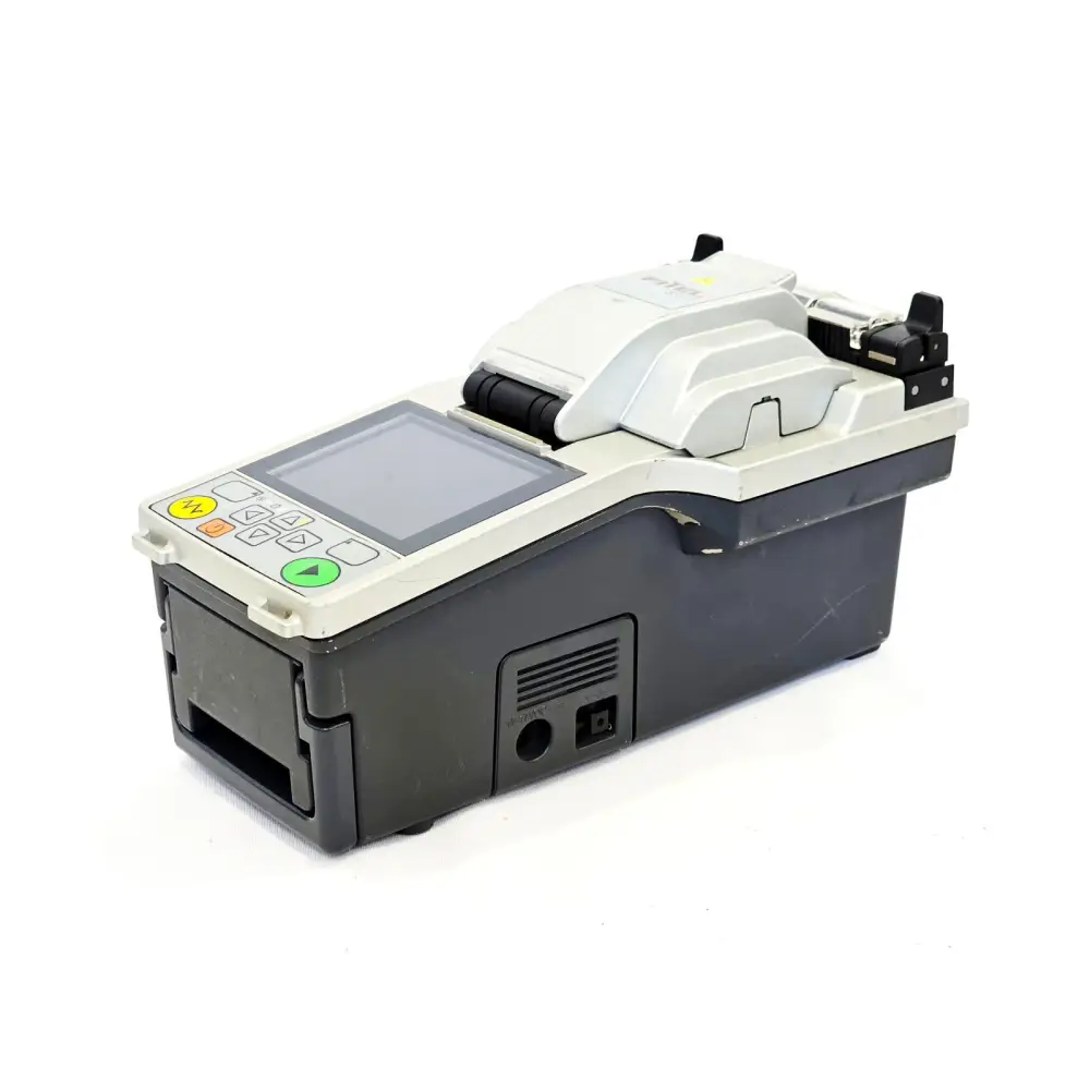 Fitel S177A fusion splicer left-side rear angle showing DC power input port and wind protector open