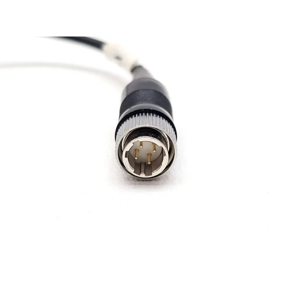 Fluke Networks FT650 Fiber Probe 4-pin male connector end of coiled cable, showing gold-plated pins in detail