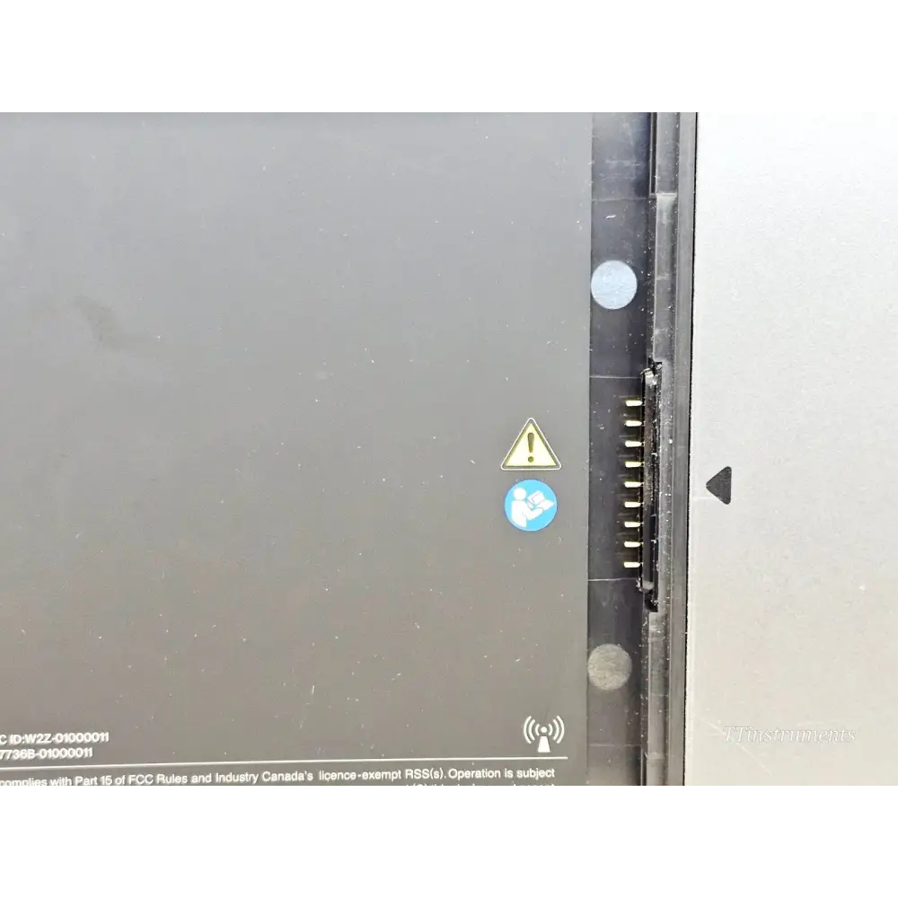 Fujifilm FDR D-EVO III C35i — close-up of battery bay connector pins, warning labels, and wireless antenna marking