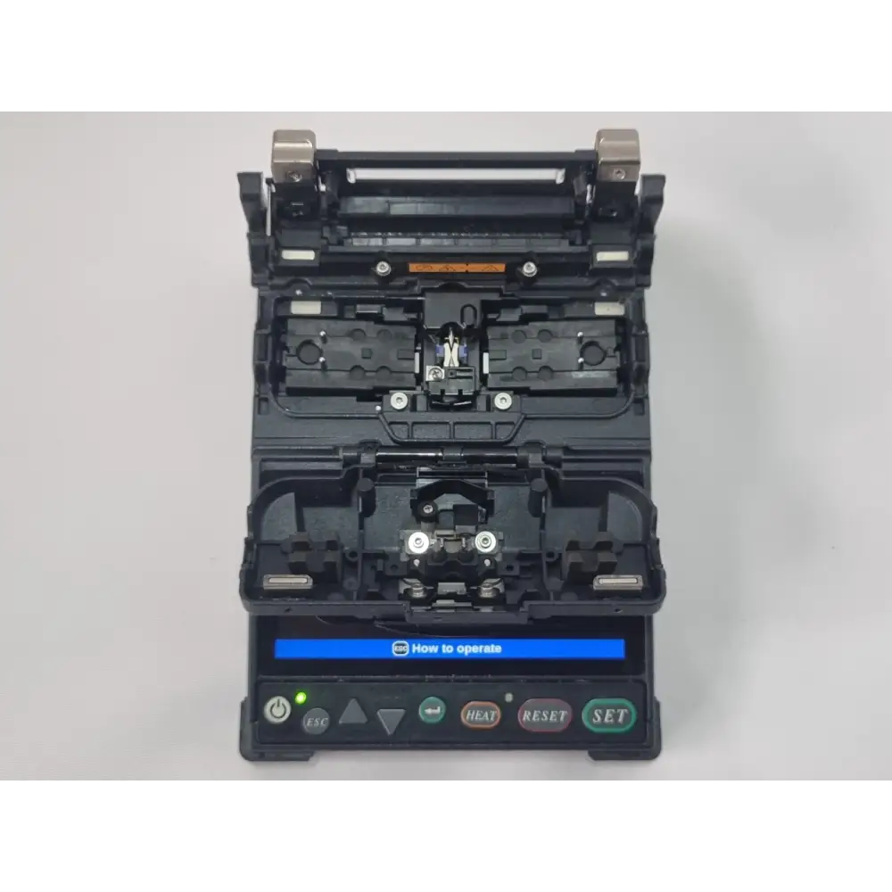 Fujikura CT-06 cleaver open showing blade mechanism and fibre clamping area