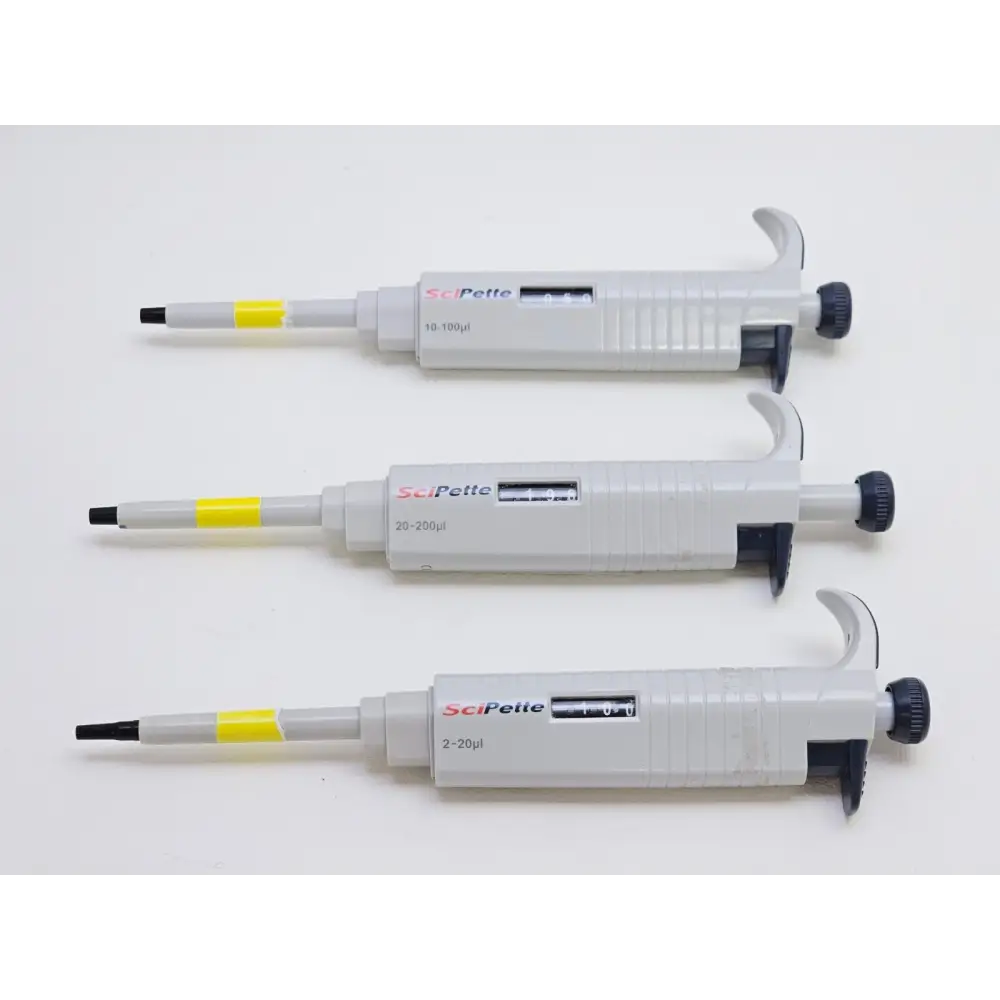 Full collection of 15 used pipettors laid out showing all brands and models included