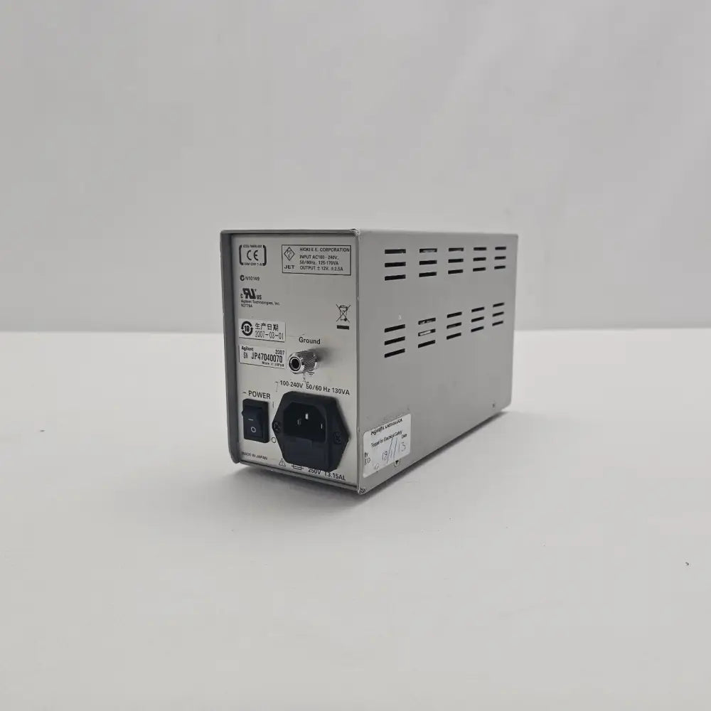 Agilent N2779A Power Supply angled rear view showing IEC inlet, power switch and Agilent Demostock electrical safety test sticker