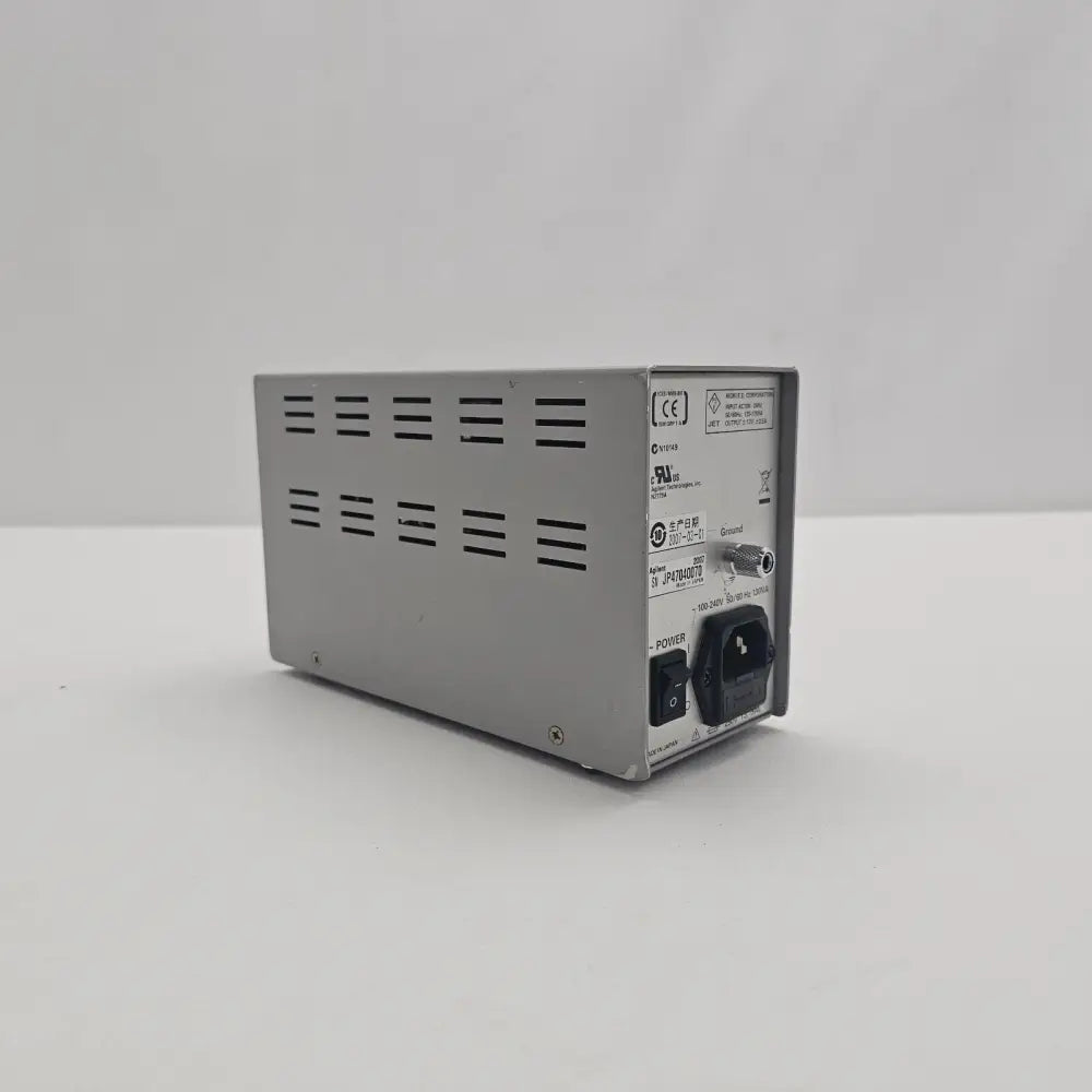 Agilent N2779A Power Supply rear panel showing IEC power inlet, rocker switch, ground terminal and serial number label