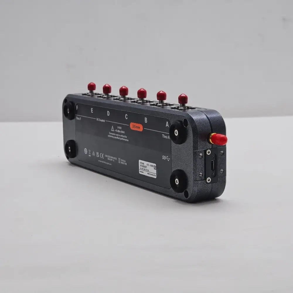 Keysight N7564A ECal Module underside angled view showing ports F–A, 3.5 mm label, serial number label and compliance marks
