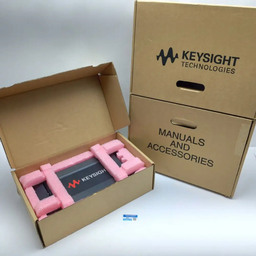 Keysight P9241A USB oscilloscope in open foam-padded box beside sealed Keysight manuals and accessories box