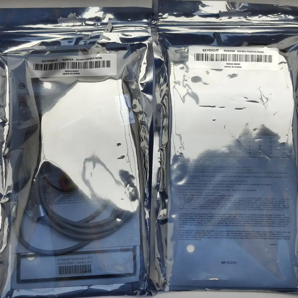 Two Keysight N2843A 500 MHz passive probes sealed in anti-static foil bags, part number N2843-60001