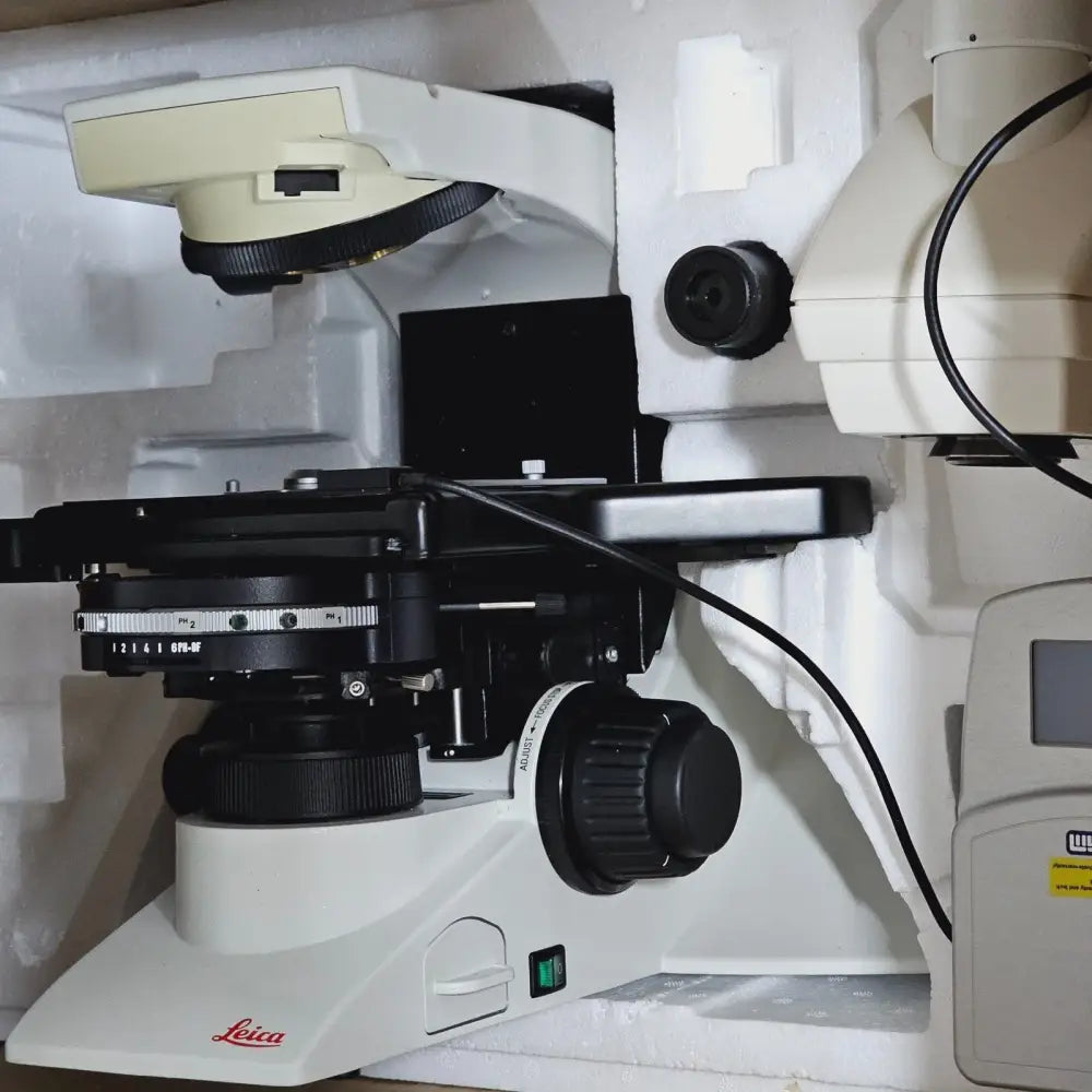 Leica DM2000 LED microscope body right-side view showing focus knobs and brightness control