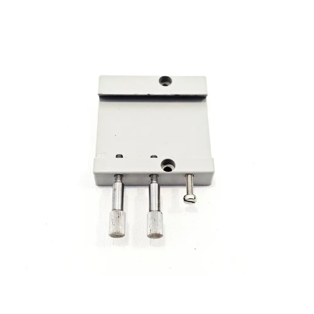 Sharplan AcuSpot 712 silver mounting plate with two knurled pins and one retaining screw, close-up view