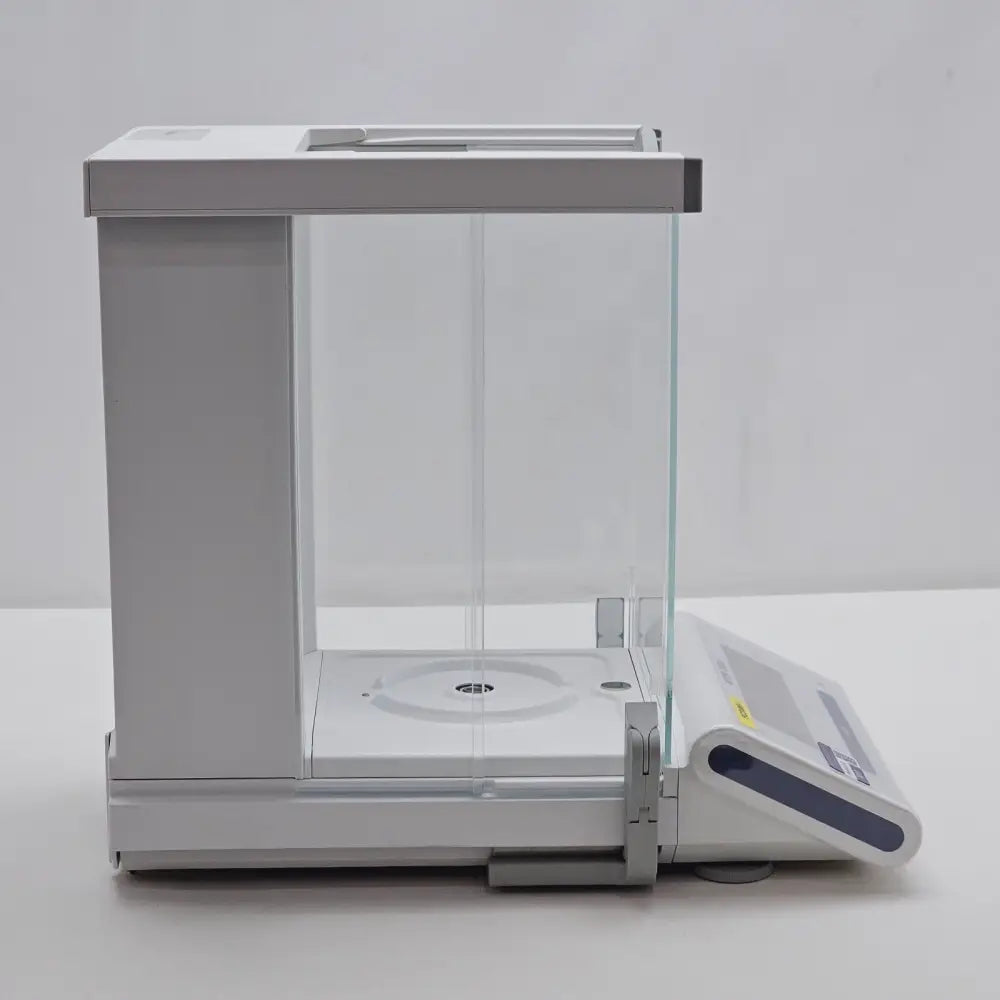 Mettler Toledo MS105DU semi-micro analytical balance with calibration weight on weighing pan
