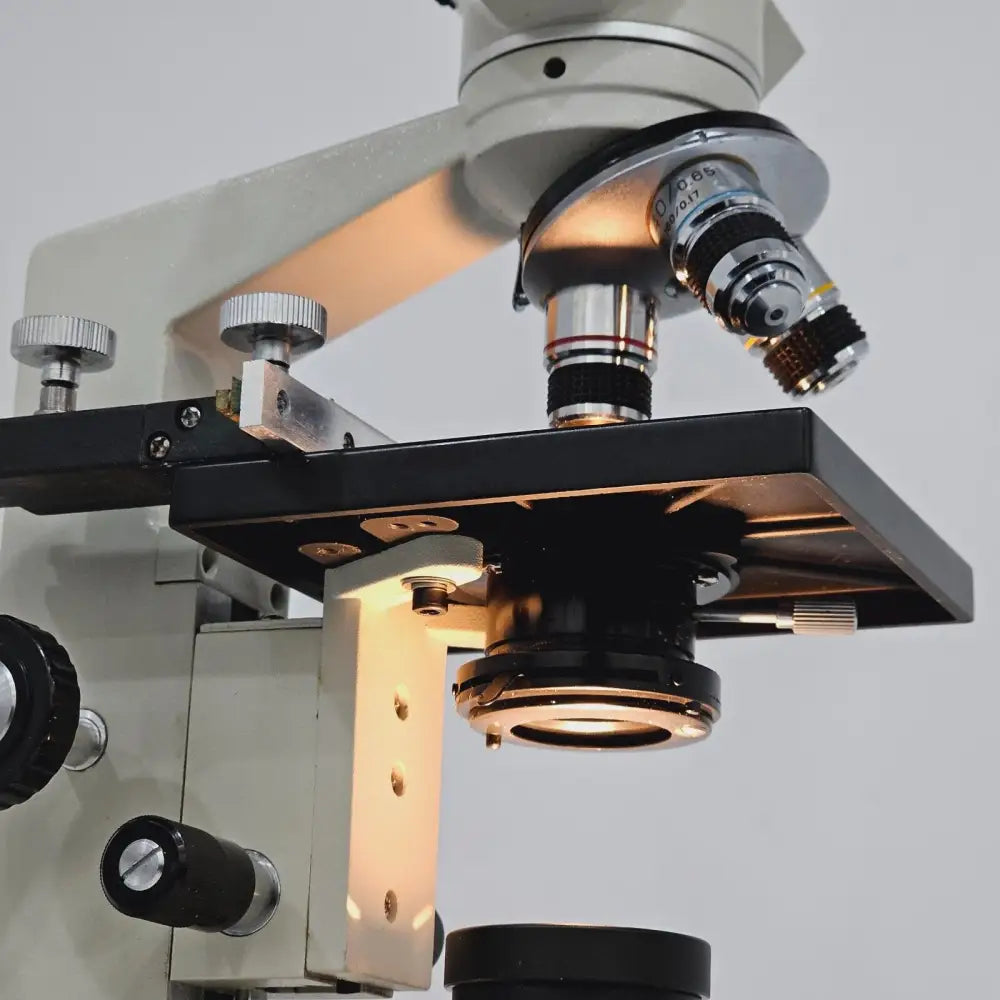 Close-up of 10/0.25 achromatic objective lens mounted on microscope nosepiece