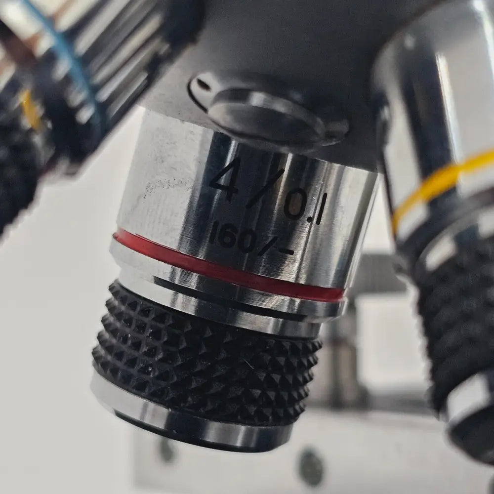 Angled three-quarter view of compound laboratory microscope showing full instrument profile