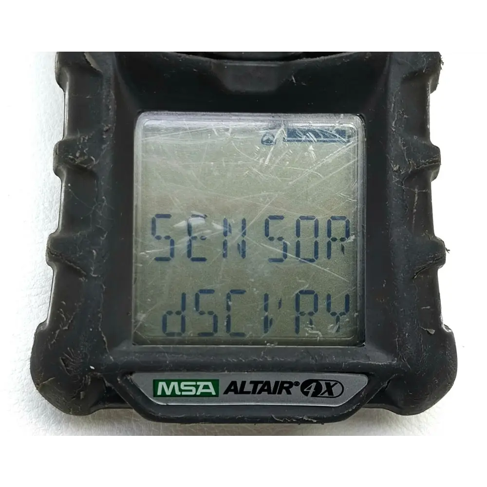 MSA ALTAIR 4X multigas detector in charcoal rubber housing on a plain surface