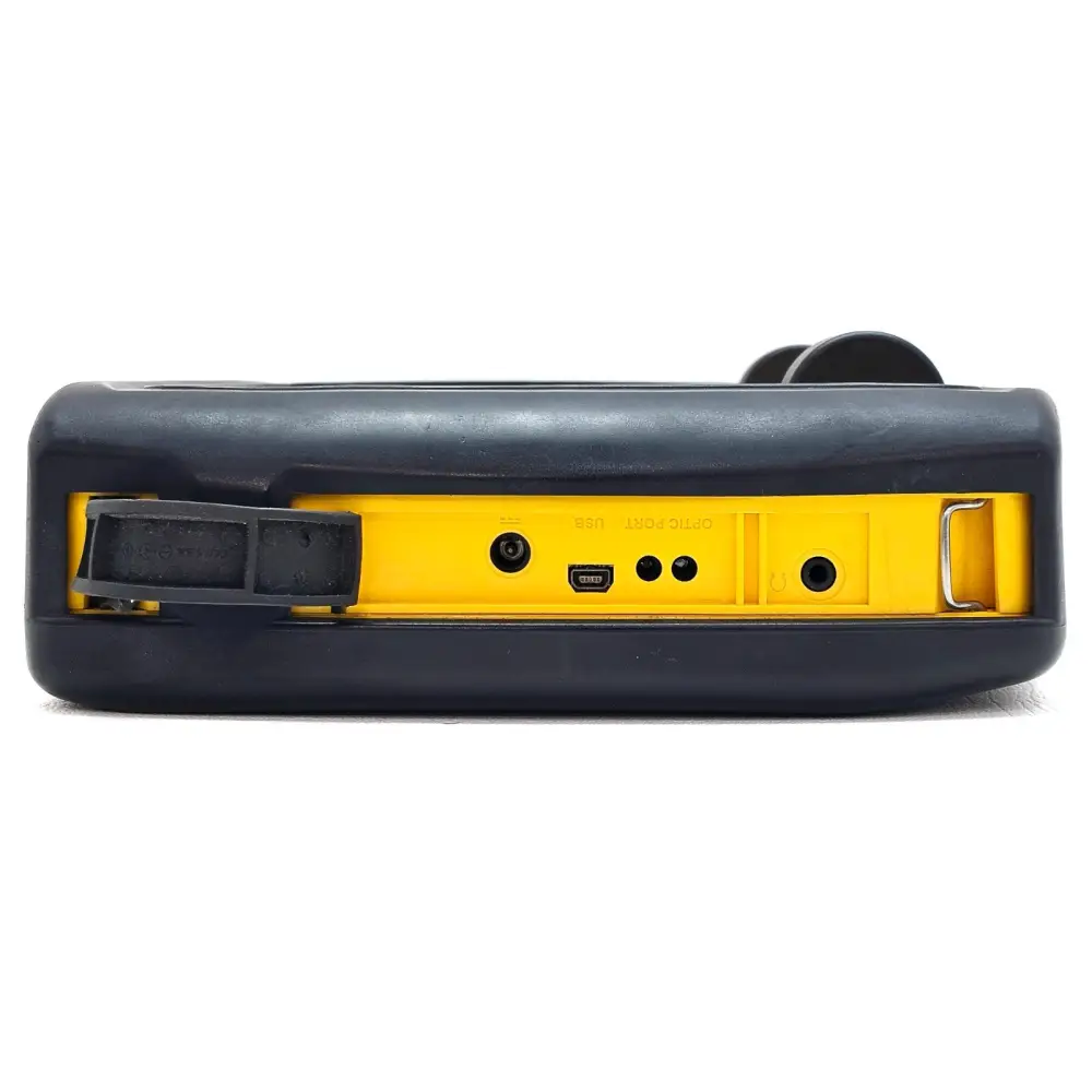 Narda SRM-3006 bottom panel showing DC charge socket, USB port, optical port and battery compartment latch