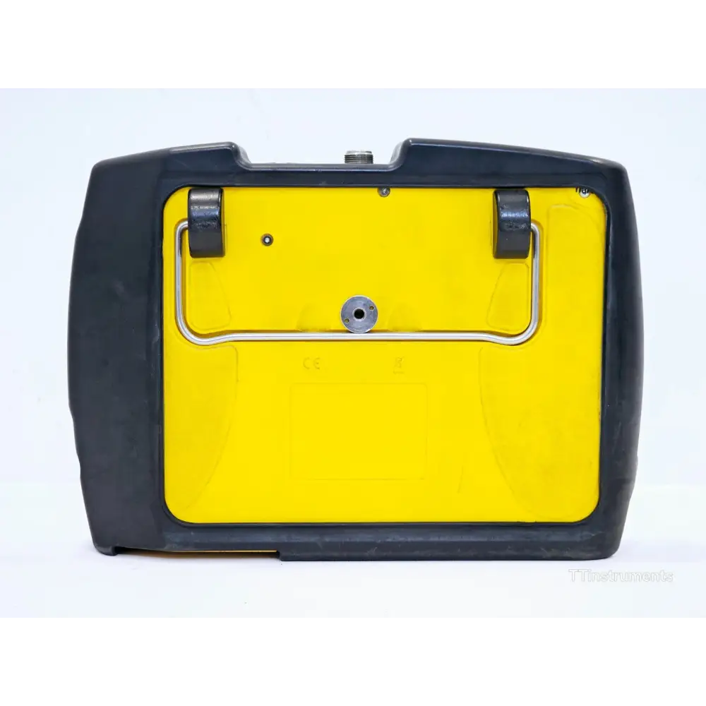 Narda SRM-3006 rear view showing yellow panel with fold-out stand, CE marking, and tripod mount point
