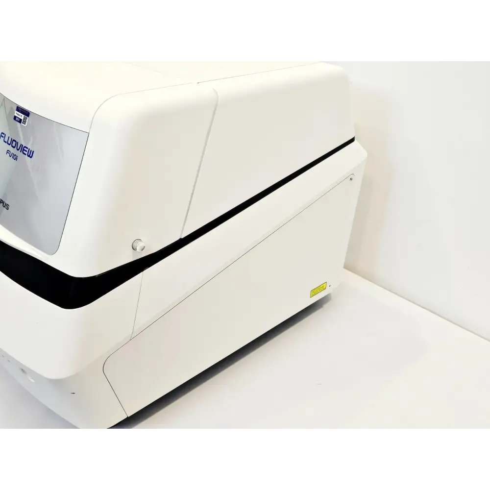Olympus FLUOVIEW FV10i confocal microscope right side angled view showing white enclosure and laser warning label