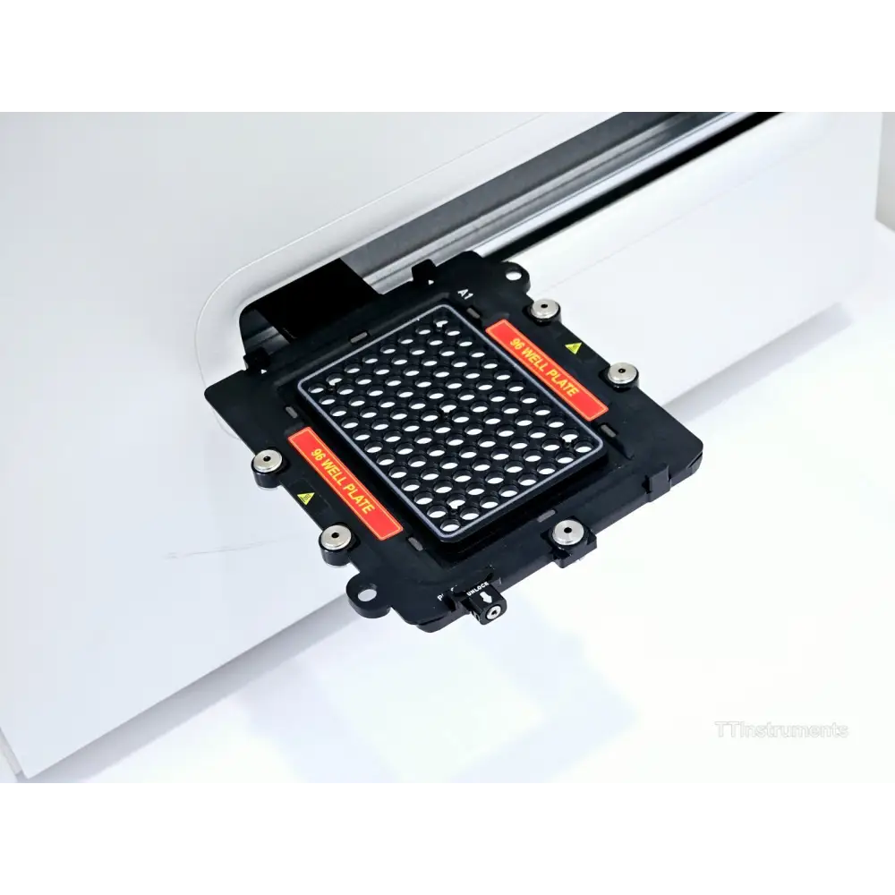 QuantStudio 12K Flex 96-well fast block installed in instrument tray showing well plate holder and lock mechanism