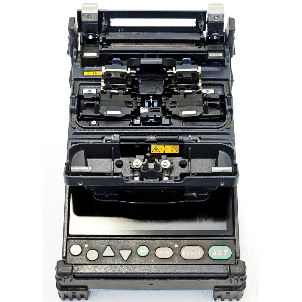 Fujikura FSM-22S fusion splicer lid open showing V-groove fibre clamps, electrode assembly and heating oven