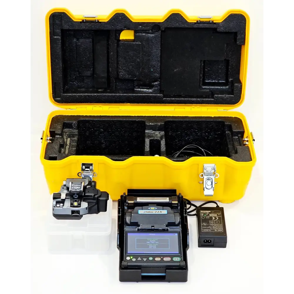 Fujikura FSM-22S fusion splicer kit laid out with CT-50 cleaver, AC adapter and yellow hard carry case open