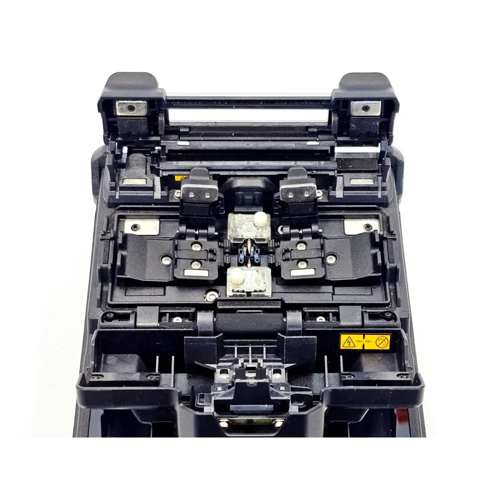 Fujikura 31S fusion splicer open splicing chamber showing V-groove alignment, fibre clamps and electrode assembly