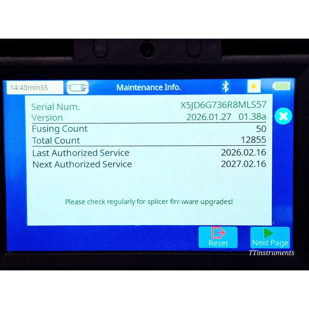 Fujikura 90S splicer side view showing battery pack, AC adapter port and carry handle