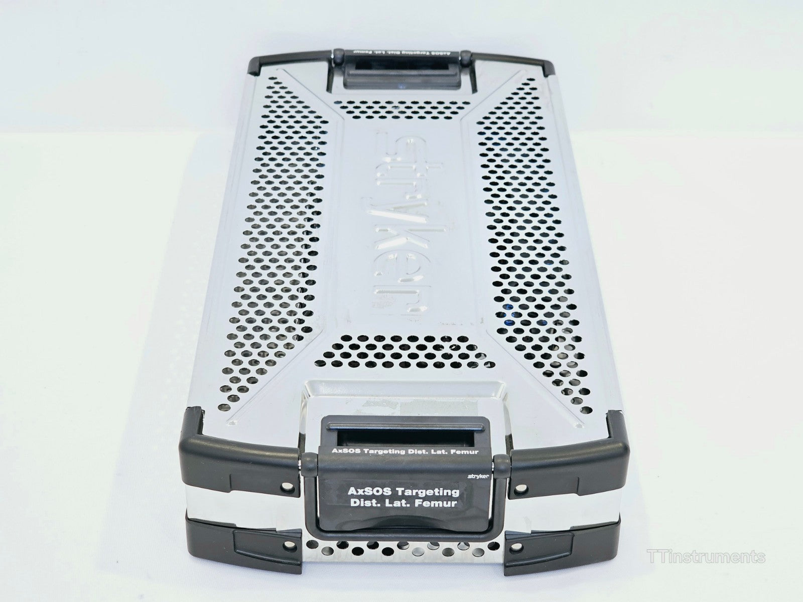 Stryker AxSOS Targeting Dist. Lat. Femur instrument tray — end view showing labelled handle with 'AxSOS Targeting Dist. Lat. Femur' and Stryker branding, tray clips and perforated lid