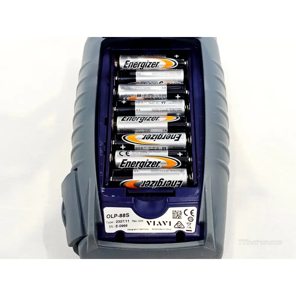 VIAVI OLP-88S battery compartment open showing six Energizer AA batteries installed, serial E-0966