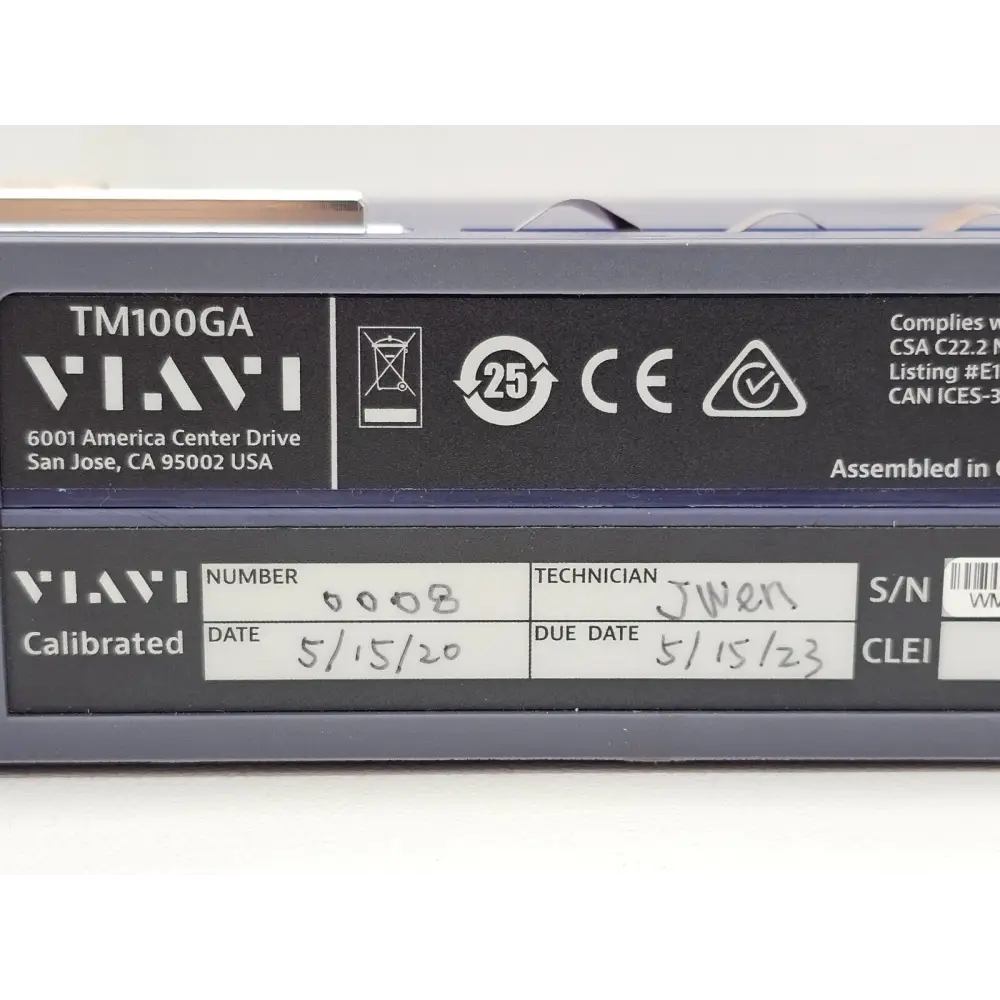 Viavi TM100GA close-up of calibration and compliance label showing serial number WMNN0041600008 and MET safety listing