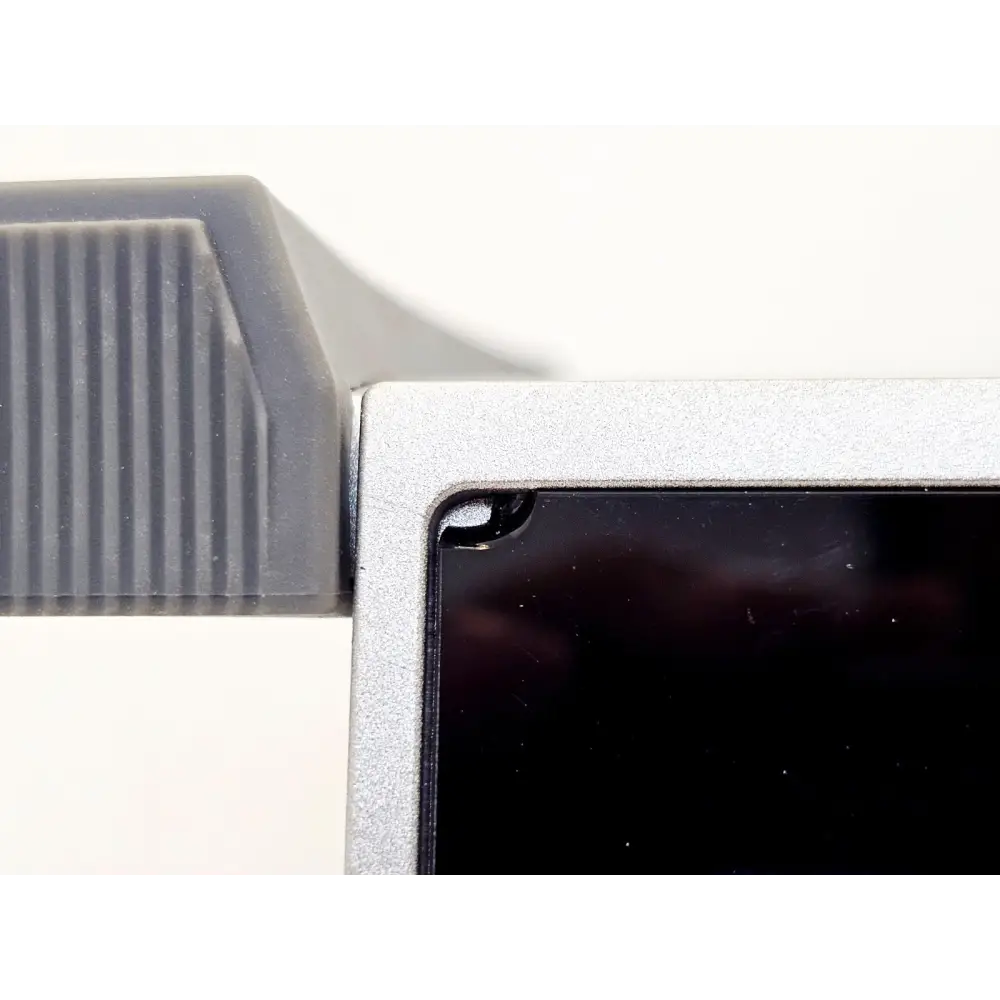 Close-up of MAP-330CH touchscreen top-left corner showing chip/crack damage to bezel and screen edge