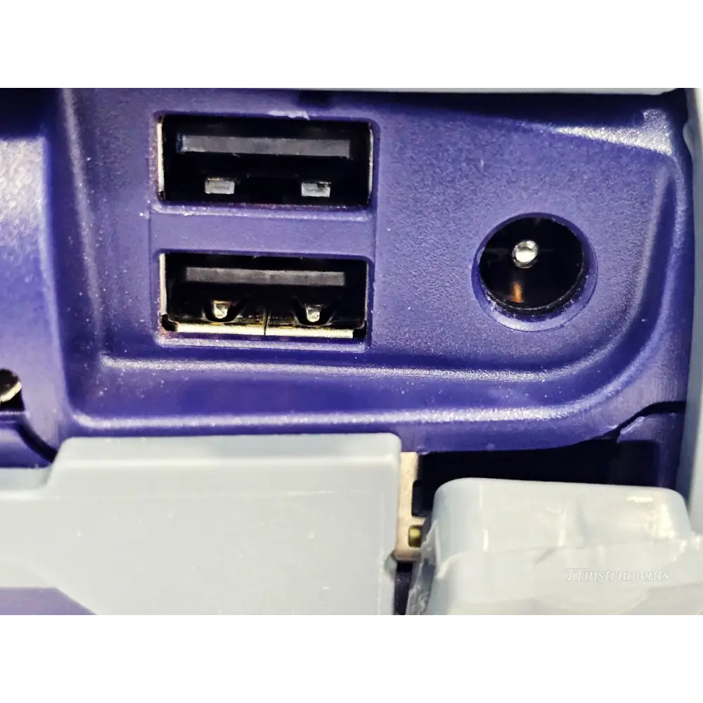 VIAVI OLP-87 side panel close-up showing dual USB-A ports and DC power jack for PS4 12V/2A power supply connection