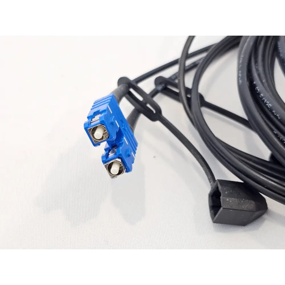 Zeiss AxioCam HRc 412-312 optical fibre cable close-up showing blue dual-fibre SC-style connector and black single connector end